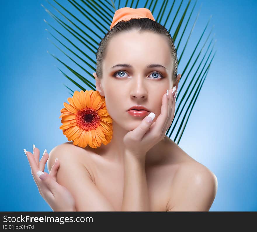 Portrait of beautiful woman with the orange flower. Portrait of beautiful woman with the orange flower.