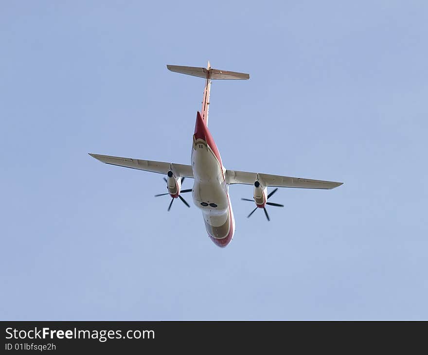 Dornier 328 airplane banking after evening takeoff