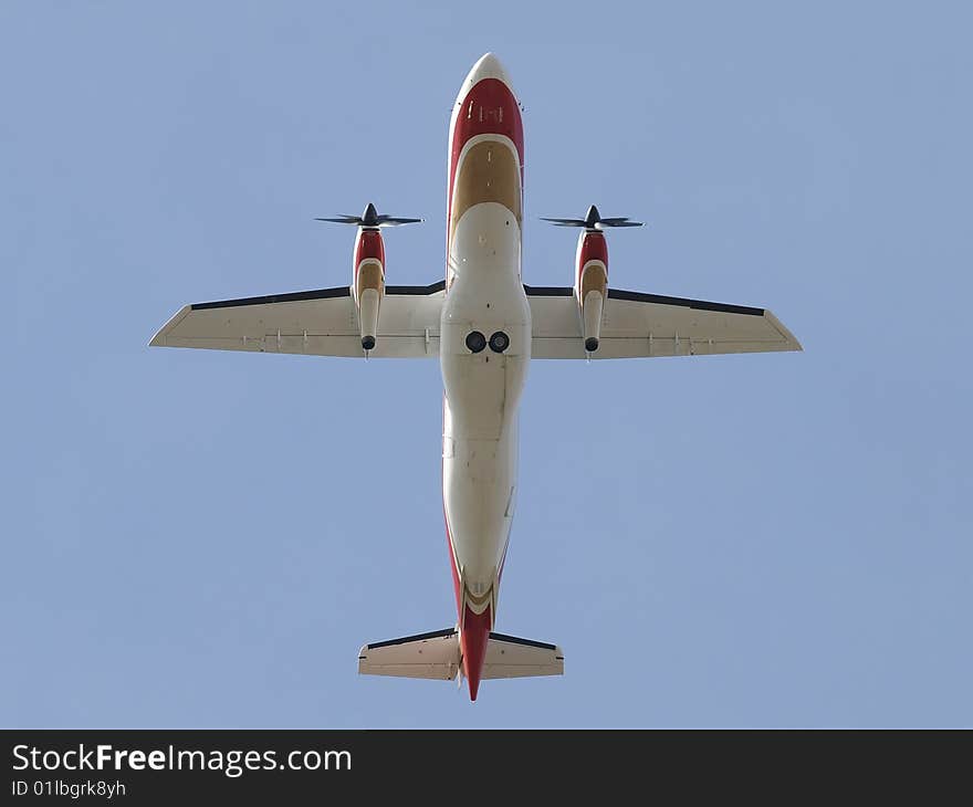 Dornier 328 airliner bottom view directly over head in flight. Dornier 328 airliner bottom view directly over head in flight