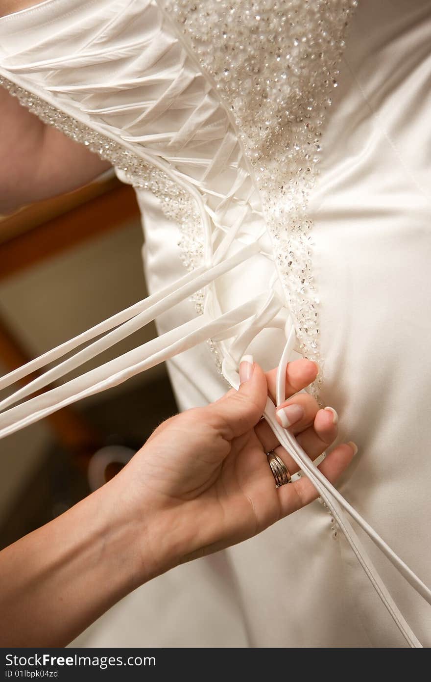 Bride getting her dress laced