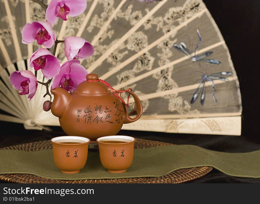 Chinese teapot and antique fan horizontal