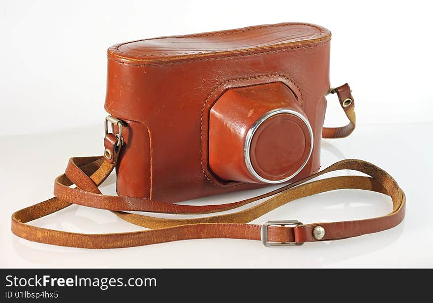 Old photo camera leather case isolated on white with reflection. Old photo camera leather case isolated on white with reflection