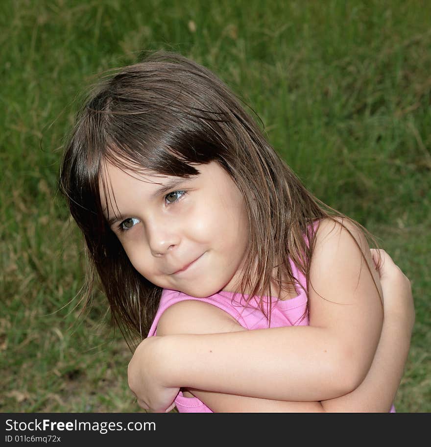 Young girl playing in field on a windy day. Young girl playing in field on a windy day.