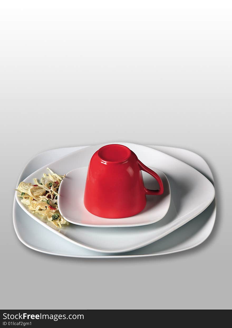 Red cup on white saucer on white background. Red cup on white saucer on white background