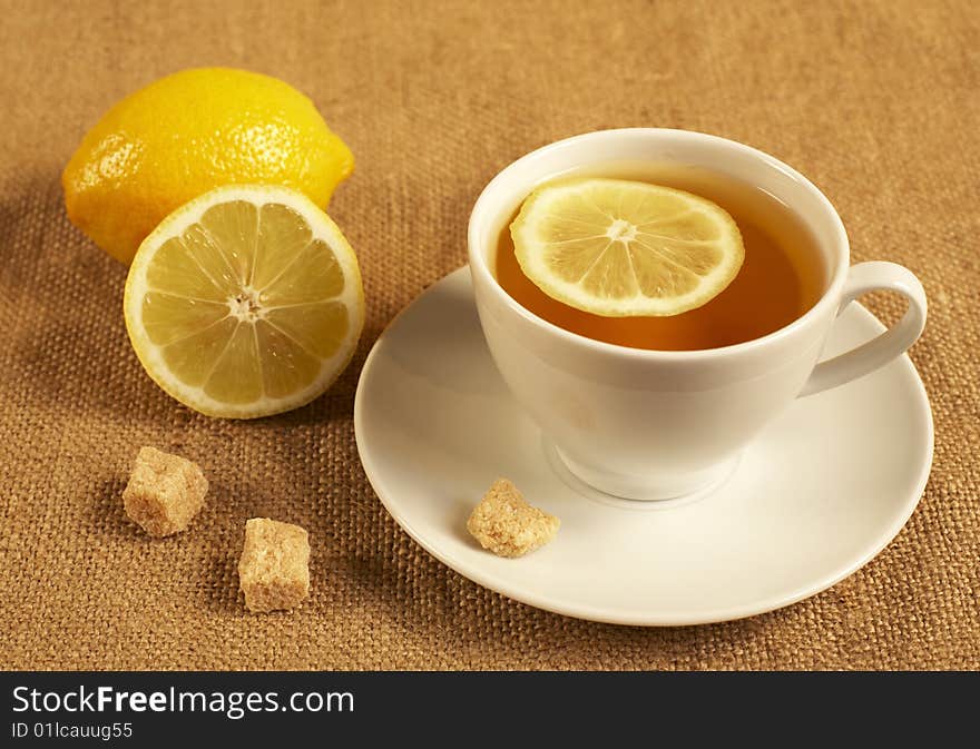 tea with lemon and sugar on the textile background