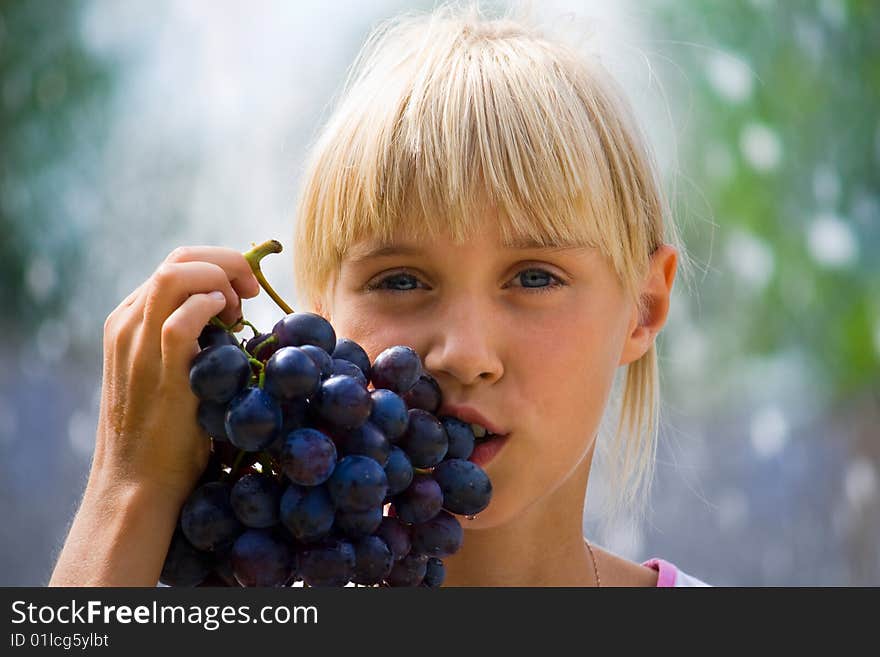 Summer vacation, schoolgirl tasty a grapes