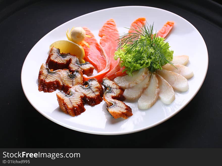 Filet of sea fish on a white dish.