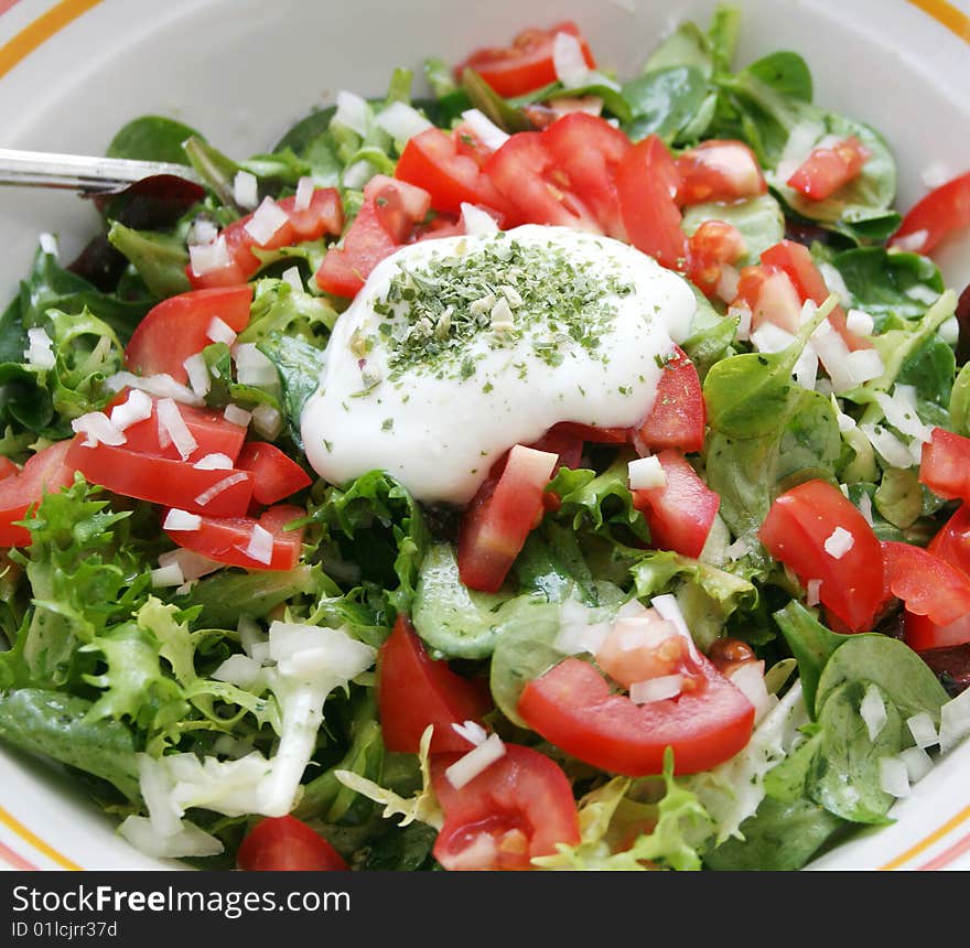 Fresh green salad with tomatoes in a bowl. Fresh green salad with tomatoes in a bowl