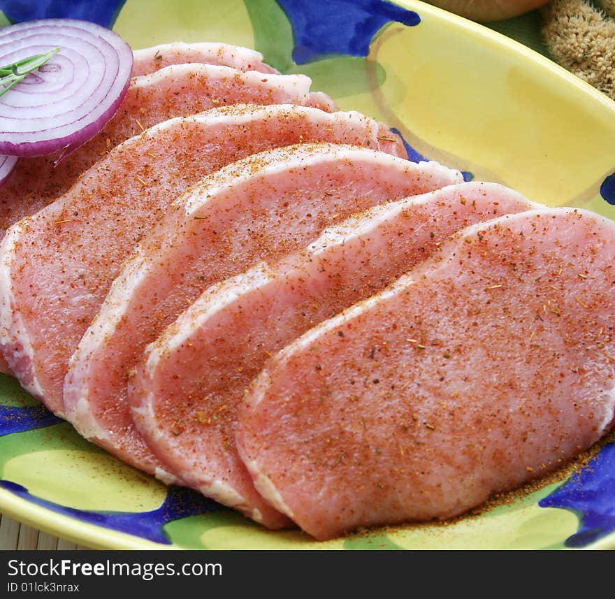 Some slices of fresh pork meat with spices. Some slices of fresh pork meat with spices