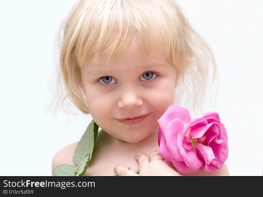 The little blonde girl holding a rose in hand. The little blonde girl holding a rose in hand