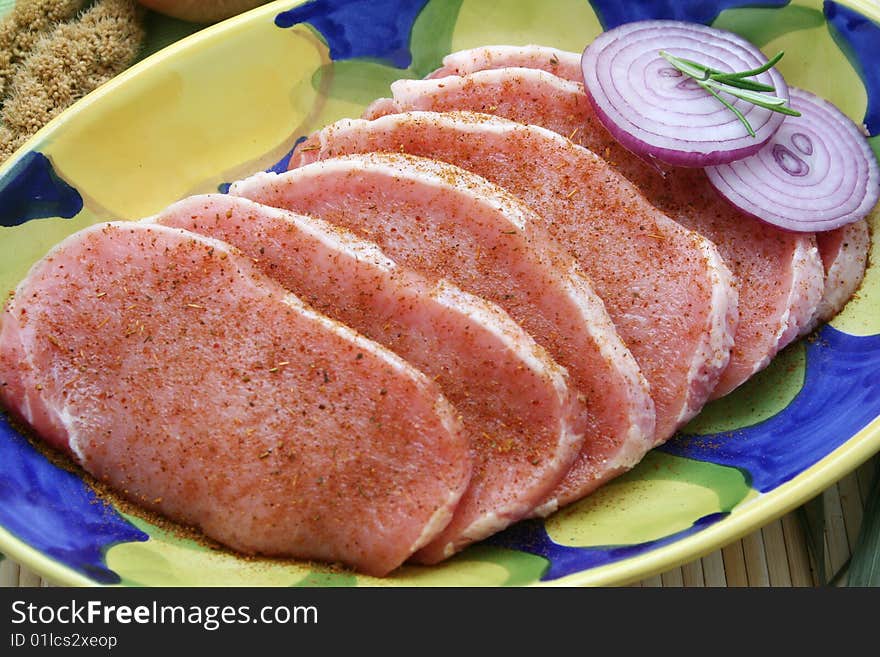 Some slices of fresh pork meat with spices. Some slices of fresh pork meat with spices