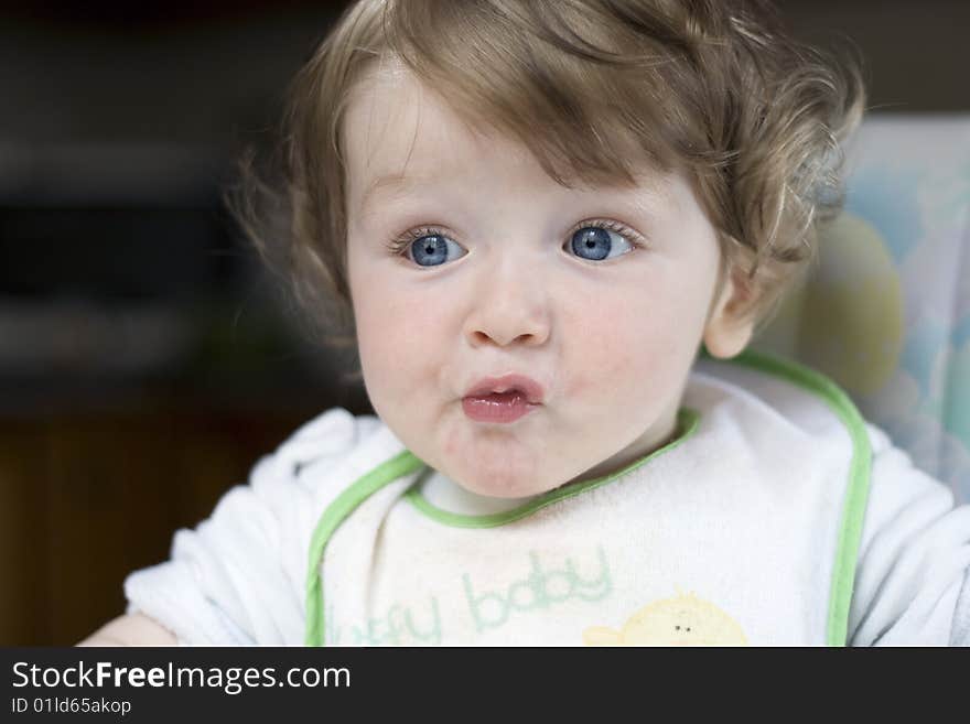 A little blue-eyed child with a funny facial expression. A little blue-eyed child with a funny facial expression