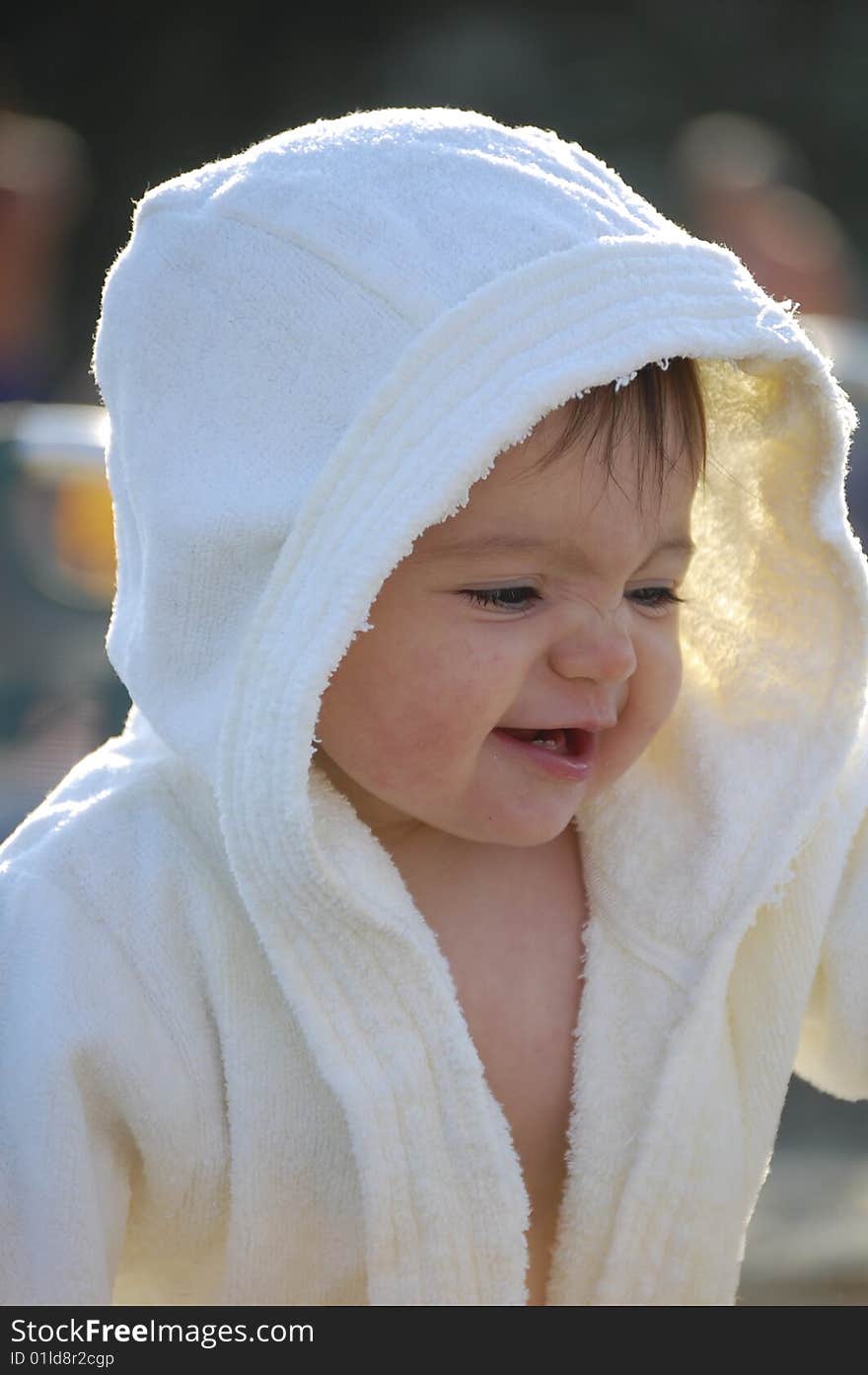 Child in white bathrobe laughing