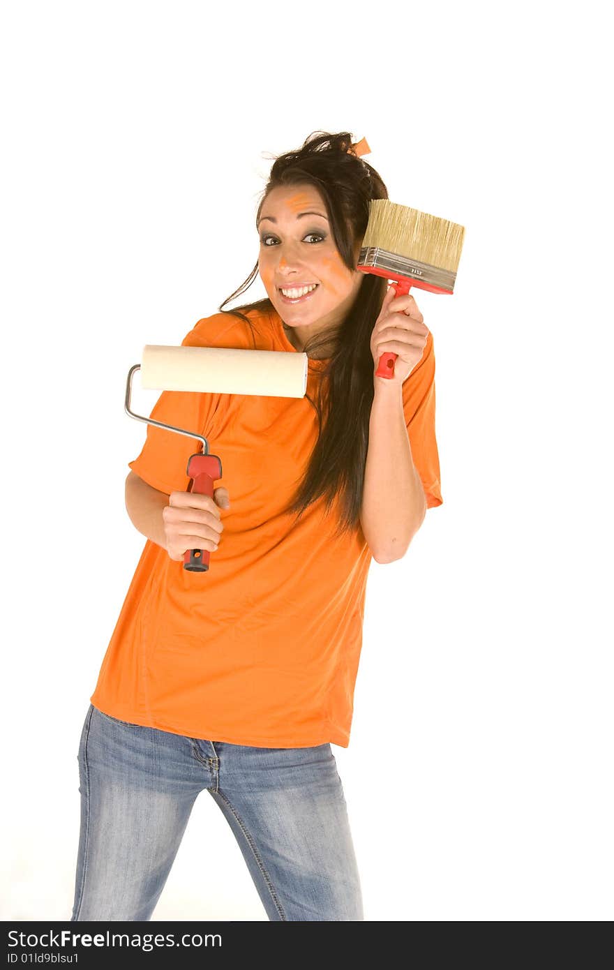 Young caucasian brunette holding a brush with orange t-shirt and orange paint on her face,making facial expression. Young caucasian brunette holding a brush with orange t-shirt and orange paint on her face,making facial expression