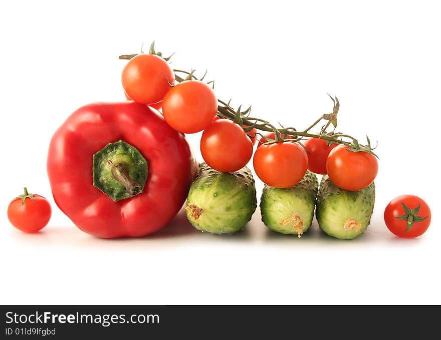 Mix of pepper, cucumbers and tomatoes isolated on white. Mix of pepper, cucumbers and tomatoes isolated on white