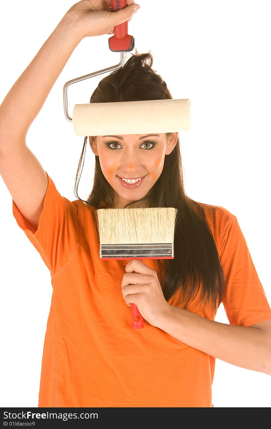 Young caucasian brunette holding a brush with orange t-shirt and orange paint on her face,making facial expression. Young caucasian brunette holding a brush with orange t-shirt and orange paint on her face,making facial expression