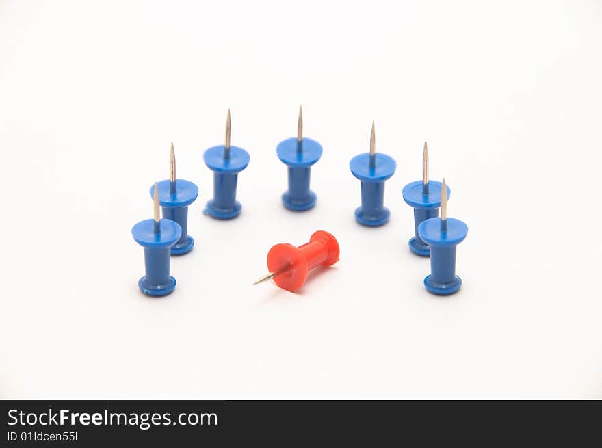 Blue push-pins isolated on white background with a red one fallen. Blue push-pins isolated on white background with a red one fallen