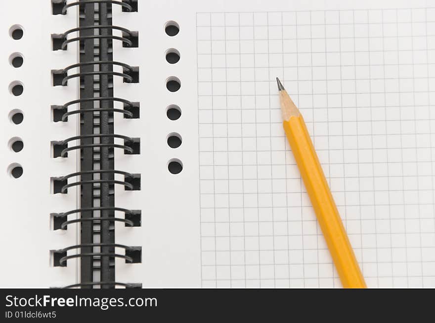 Blank spiral notebook with yellow pencil