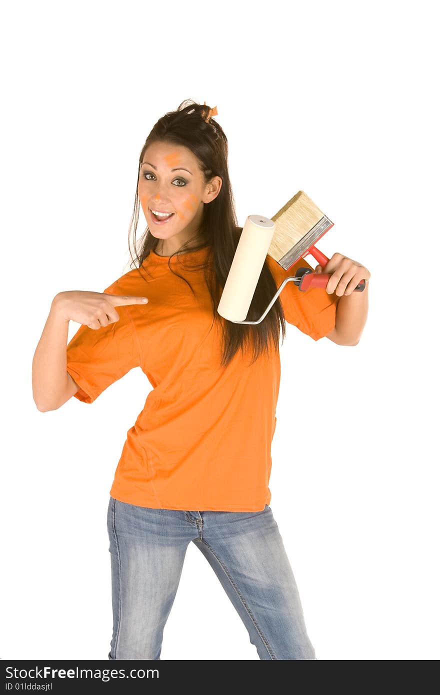 Young caucasian brunette holding a brush with orange t-shirt and orange paint on her face,making facial expression. Young caucasian brunette holding a brush with orange t-shirt and orange paint on her face,making facial expression