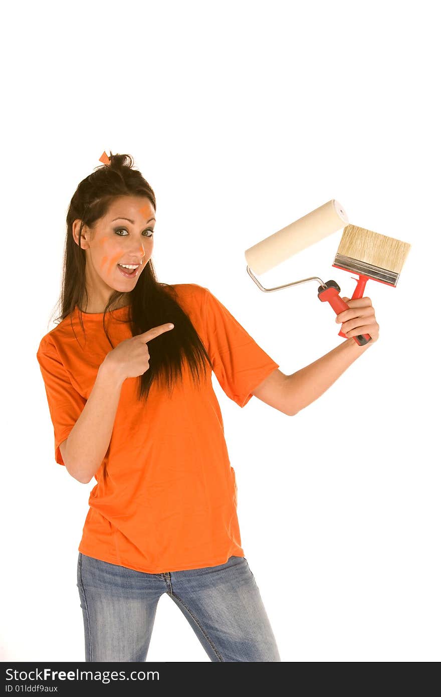 Young caucasian brunette holding a brush with orange t-shirt and orange paint on her face,making facial expression. Young caucasian brunette holding a brush with orange t-shirt and orange paint on her face,making facial expression