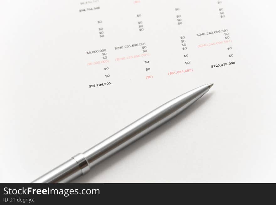 Elegant silver pen on financial papers