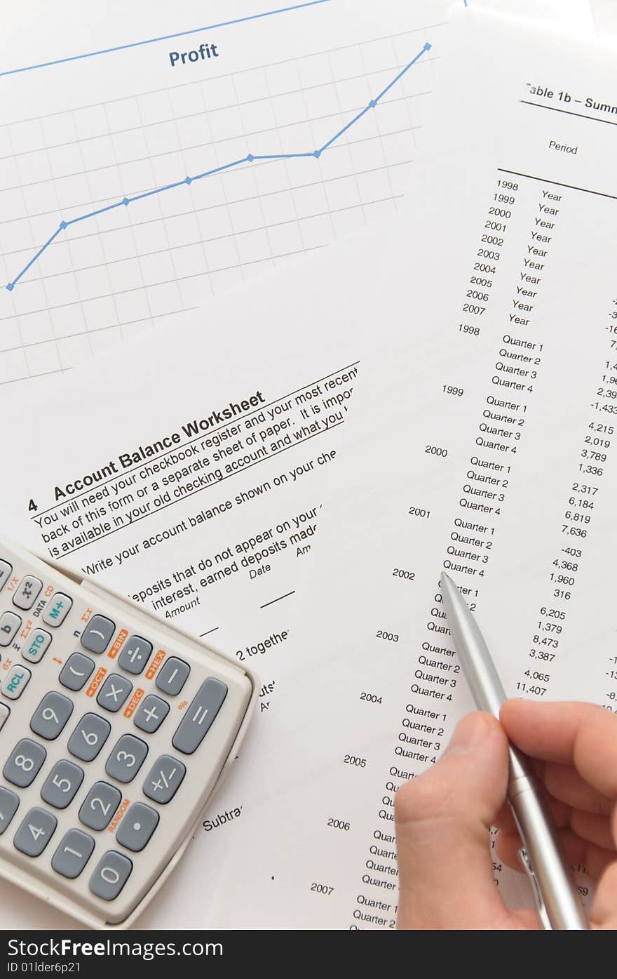 Businessman analyzing financial figures on account balance worksheet using scientific calculator