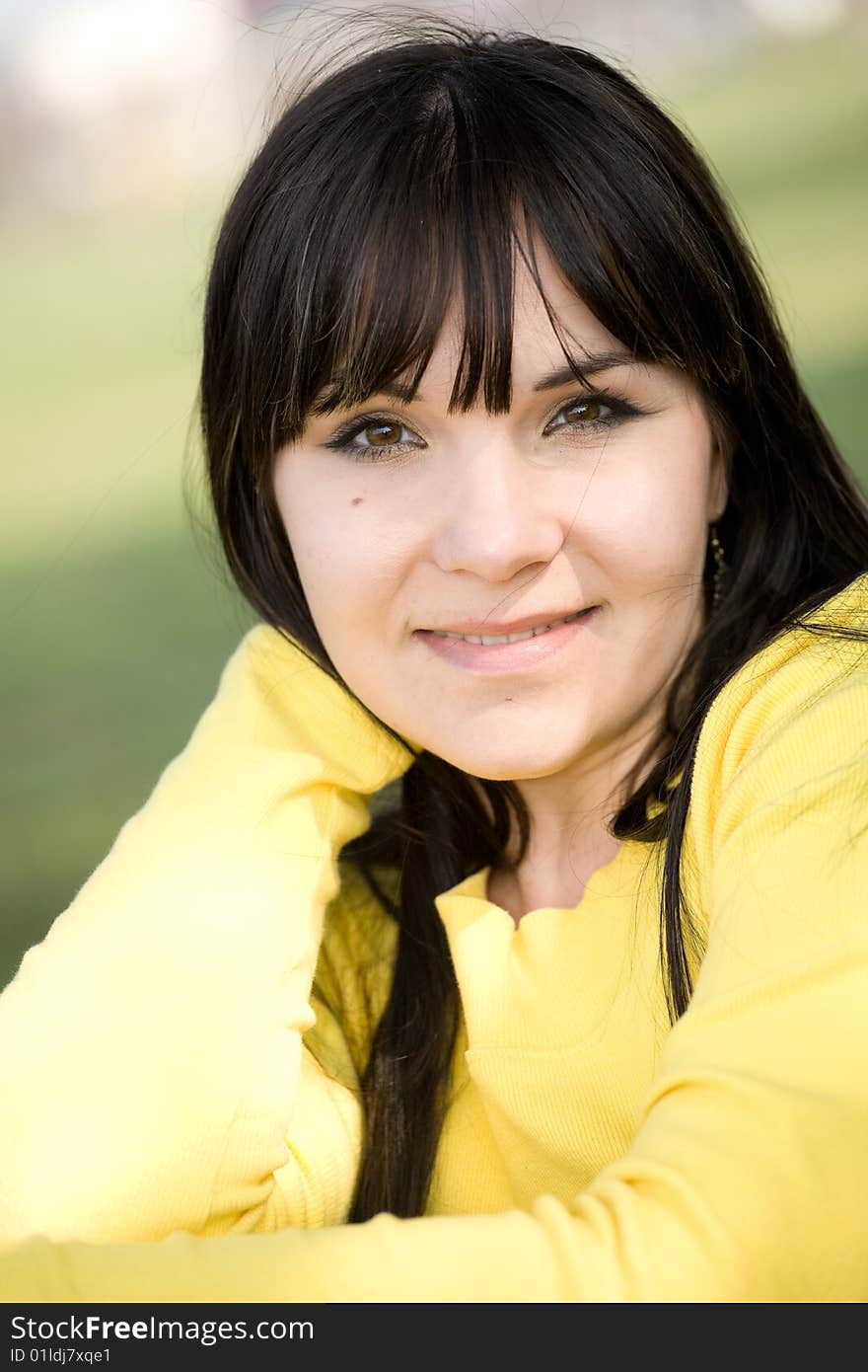 Happy brunette woman relaxing in park