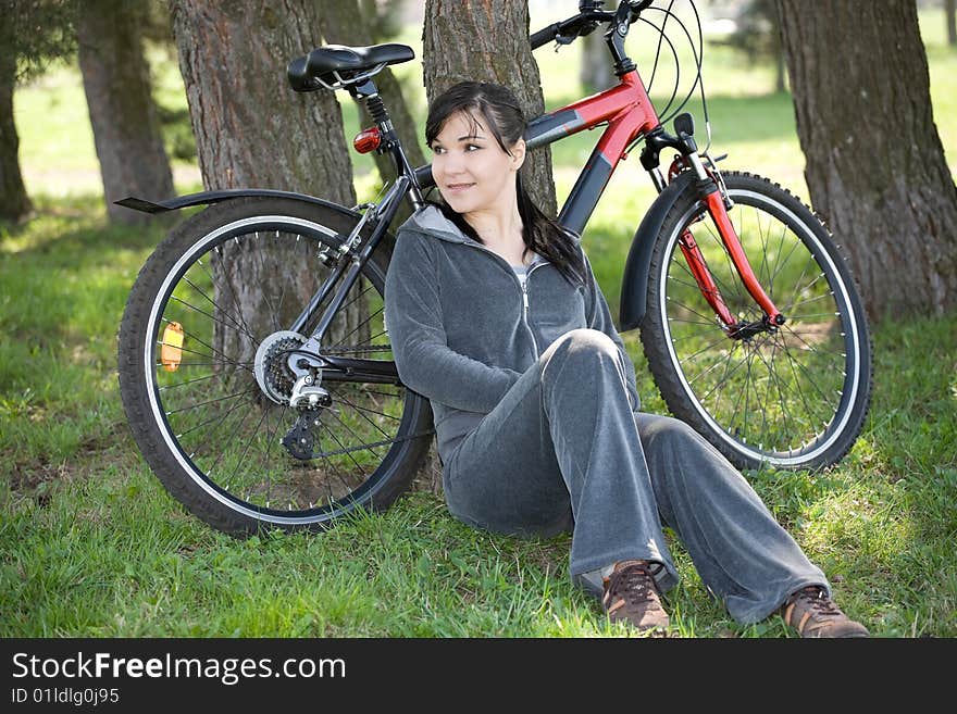 Happy woman with bike in park. Happy woman with bike in park