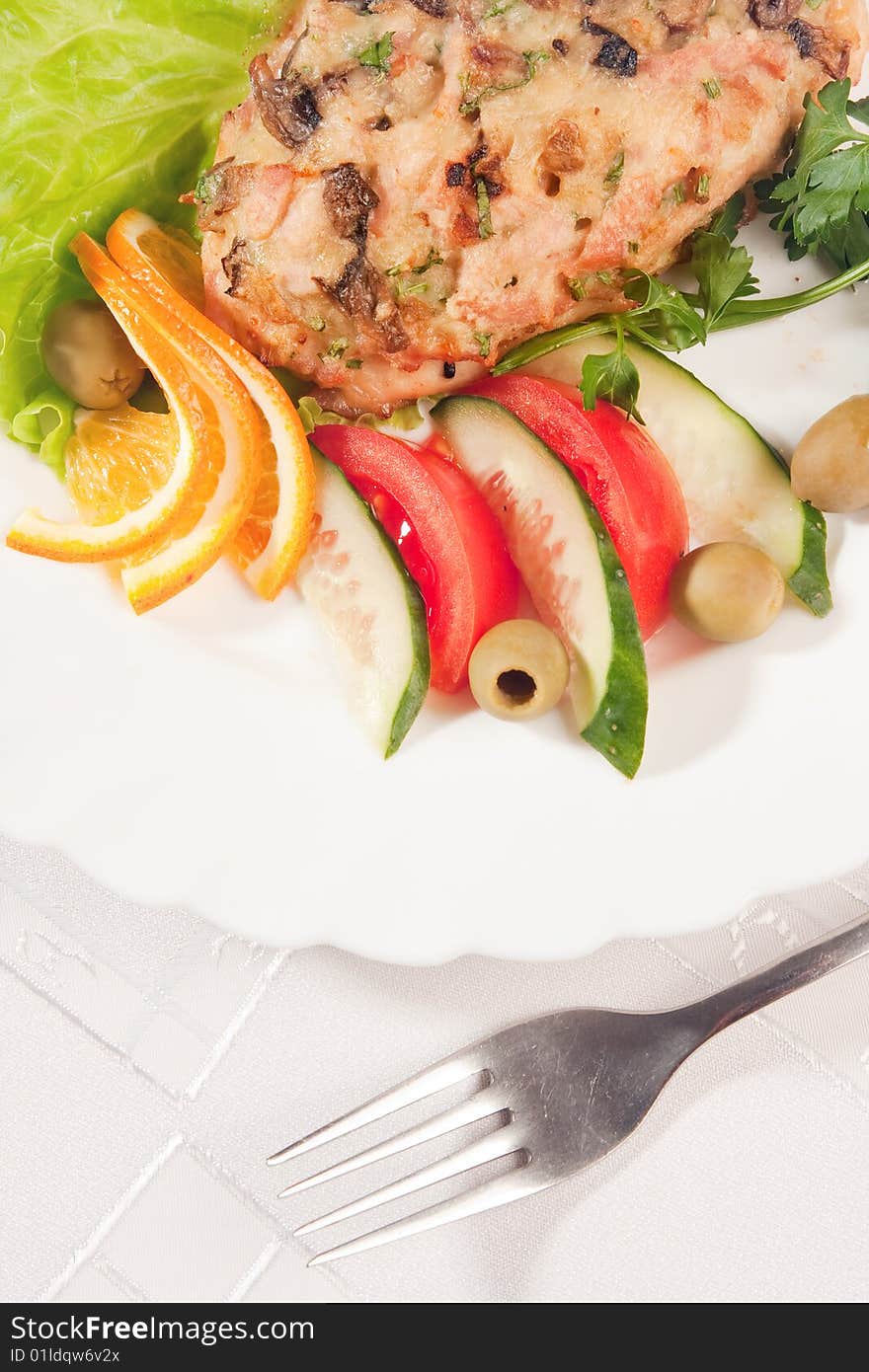 Fork with backed meat and salad