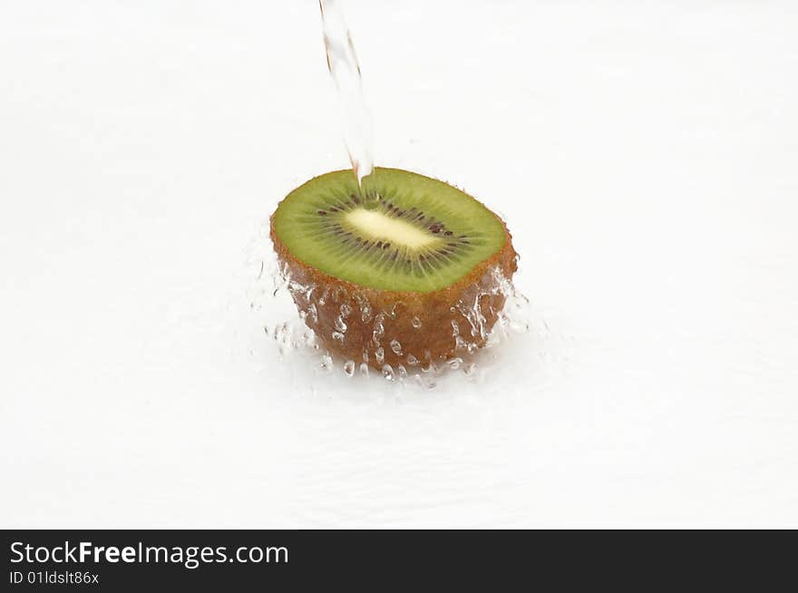 Crystal,clean Water Splashing On A Ripe Kiwi.