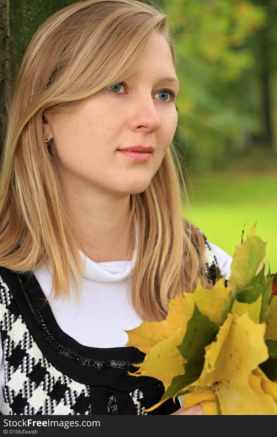 Young beautiful woman with leaves