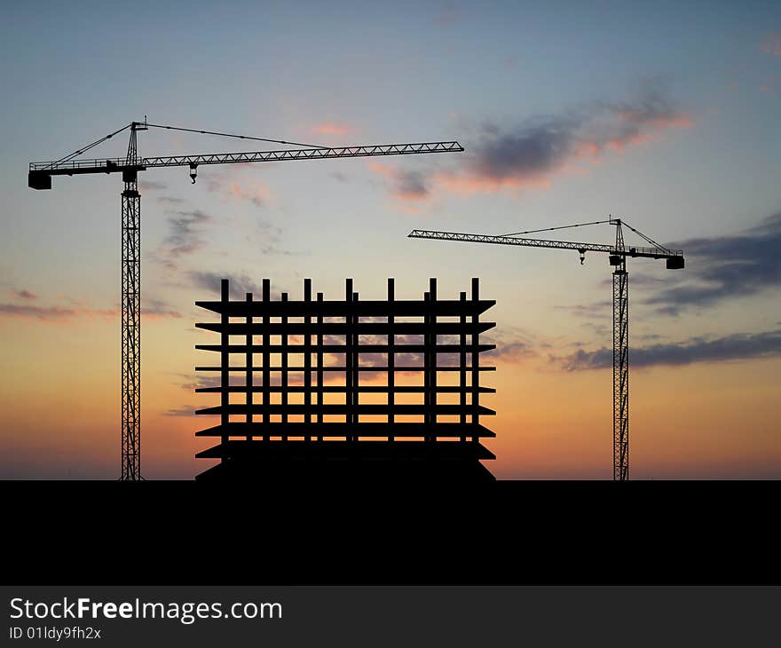 Two cranes build construction over sunset. Two cranes build construction over sunset