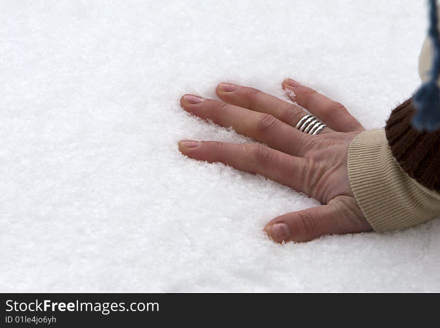 Five fingers or hand with ring lays on cold snow. Five fingers or hand with ring lays on cold snow