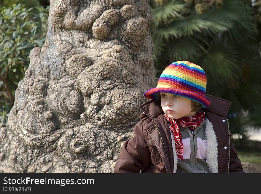 Portait of a sweet girl sitting in the park