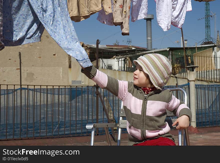 Portrait of a sweet girl with the clothesline. urban scene