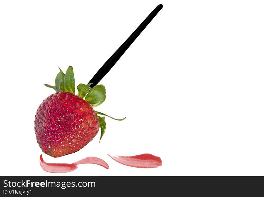 A paintbrush with strawberry tip painting red. A paintbrush with strawberry tip painting red.