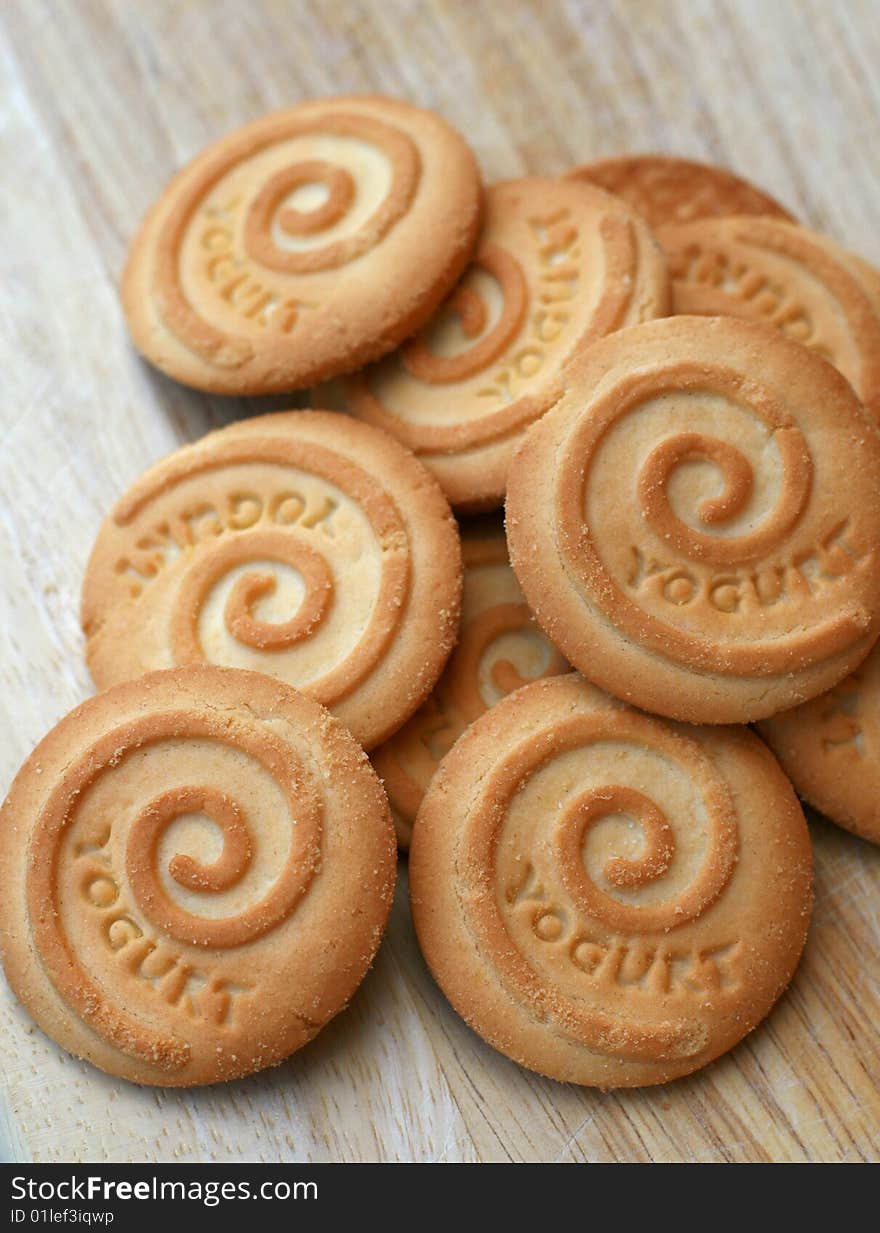 A bunch of yoghurt biscuits on a wooden chopping board