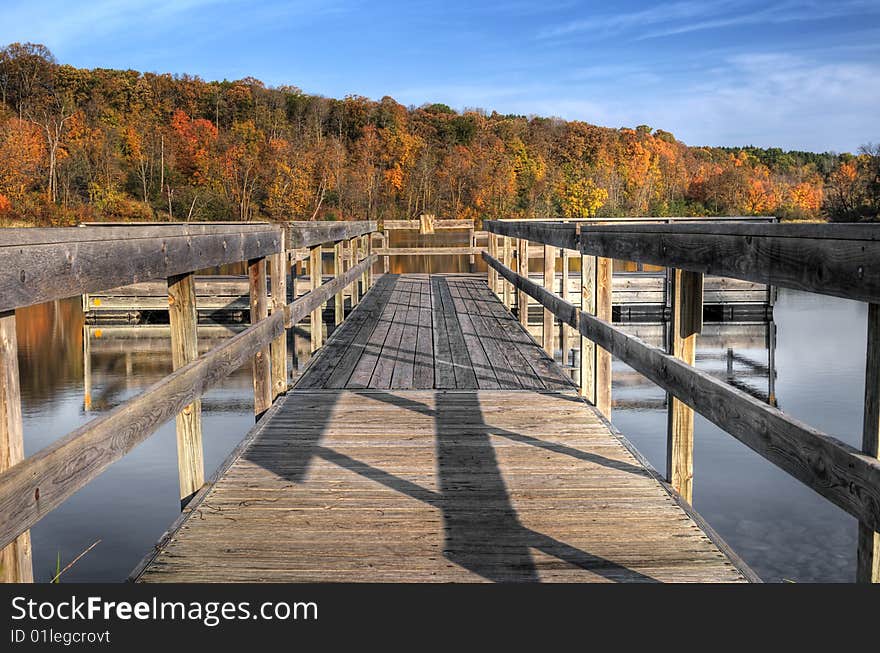 Autumn Dock - close up of dock on lake with autumn trees