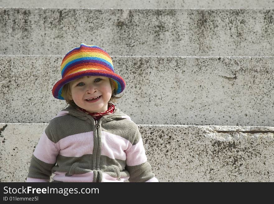 Portrait of a sweet girl sitting on the steps