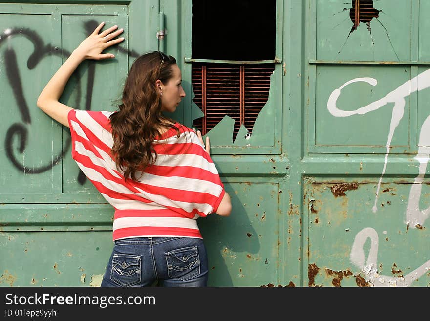 Fashion woman posing outdoor at the wall. Fashion woman posing outdoor at the wall