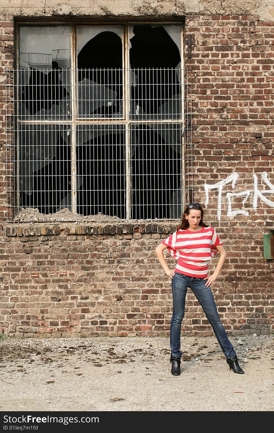 Fashion woman posing at the old wall