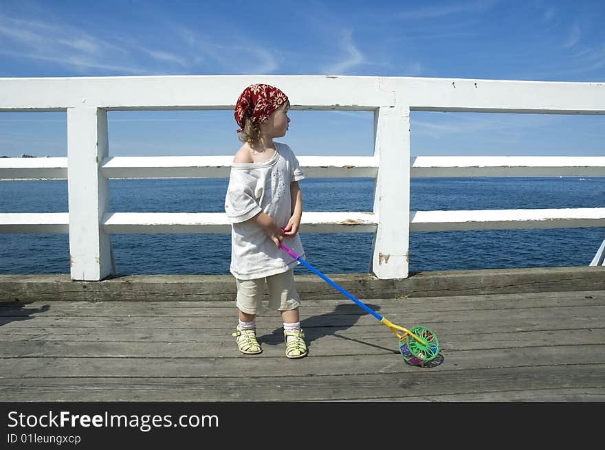 Beach day. little girl looking at the water. Beach day. little girl looking at the water