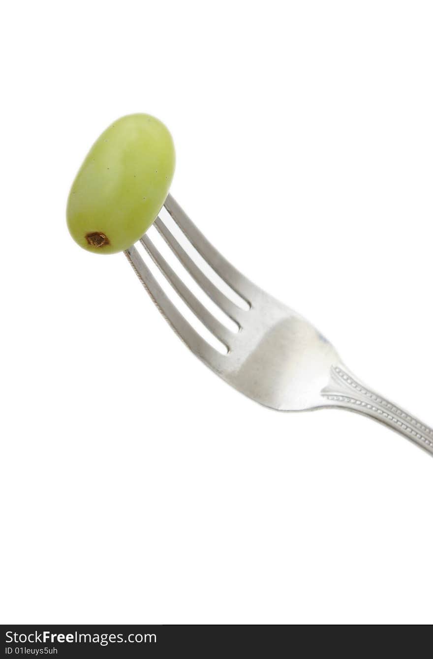 A fork with a grape on it to show healthy eating. A fork with a grape on it to show healthy eating.