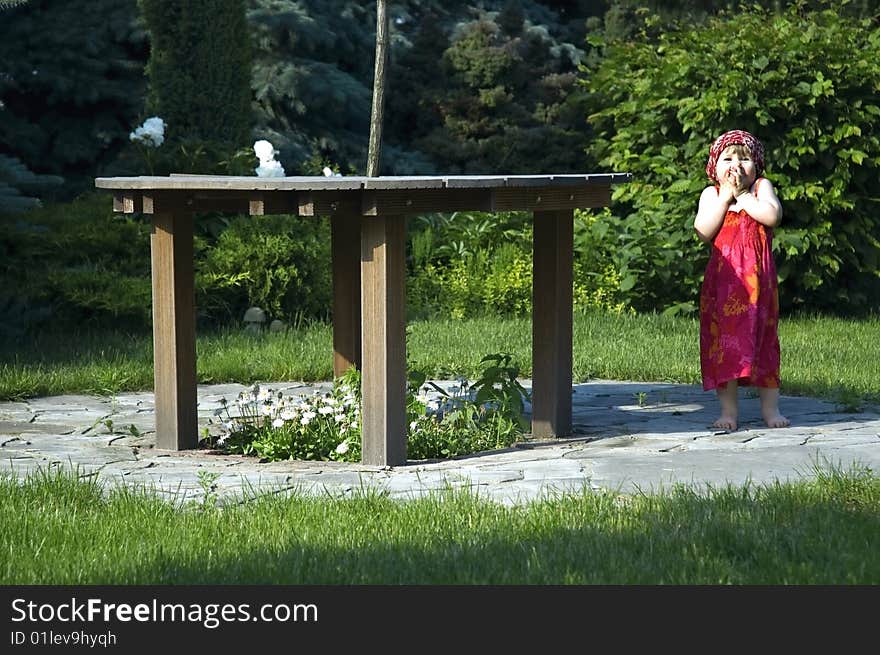 Happy little girl playing in the garden. Happy little girl playing in the garden