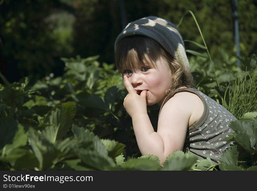 Two-year-old girl enjoying a fresh fruit. Two-year-old girl enjoying a fresh fruit