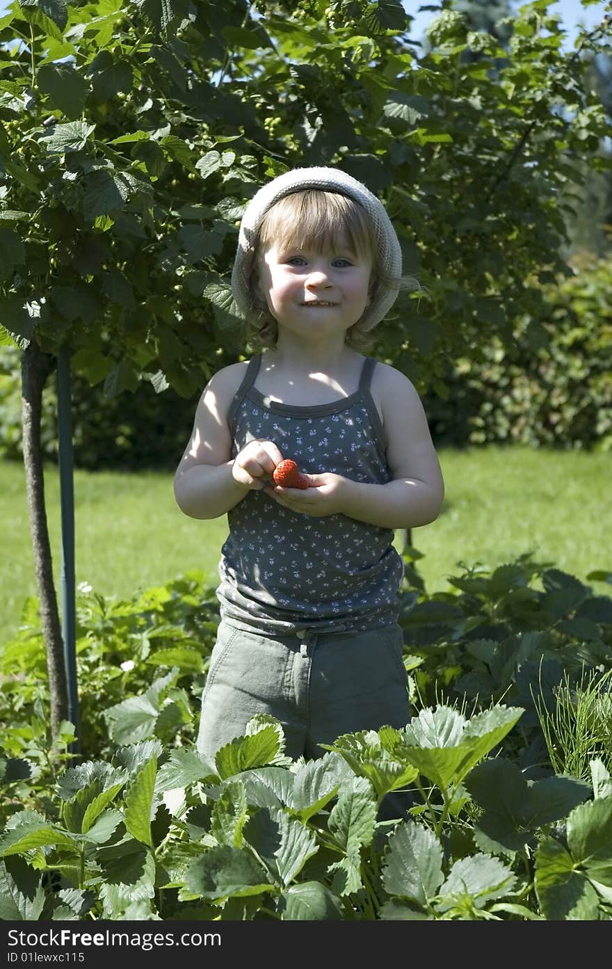 Two-year-old girl enjoying a fresh fruit. Two-year-old girl enjoying a fresh fruit