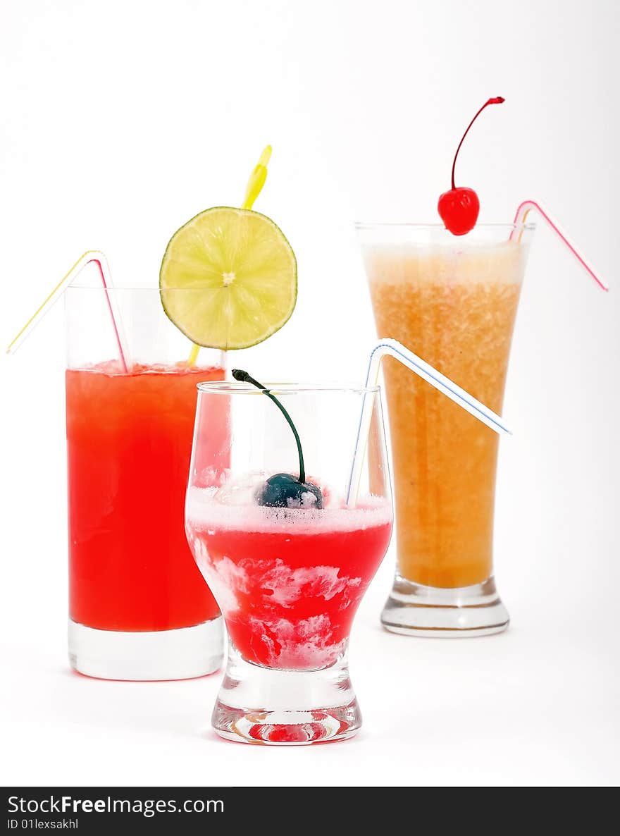 Beautiful fruit cocktails with ice, a cherry and a lemon