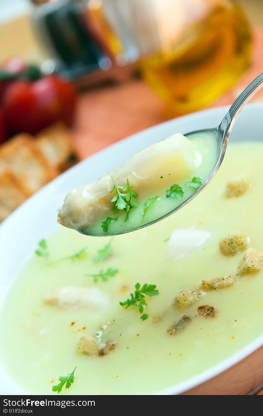 Soup of asparagus and croutons, close up