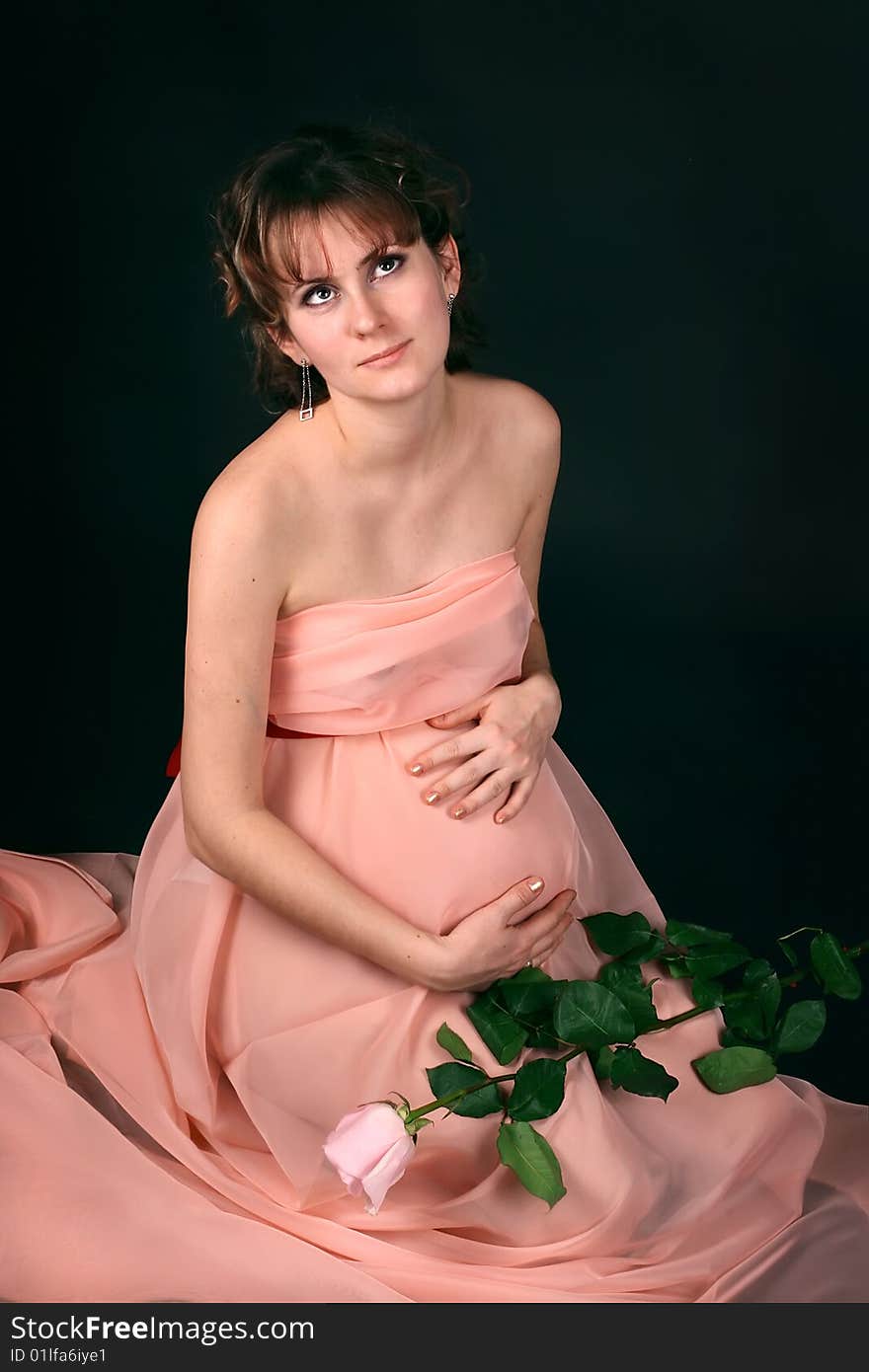 Pregnant woman on dark background