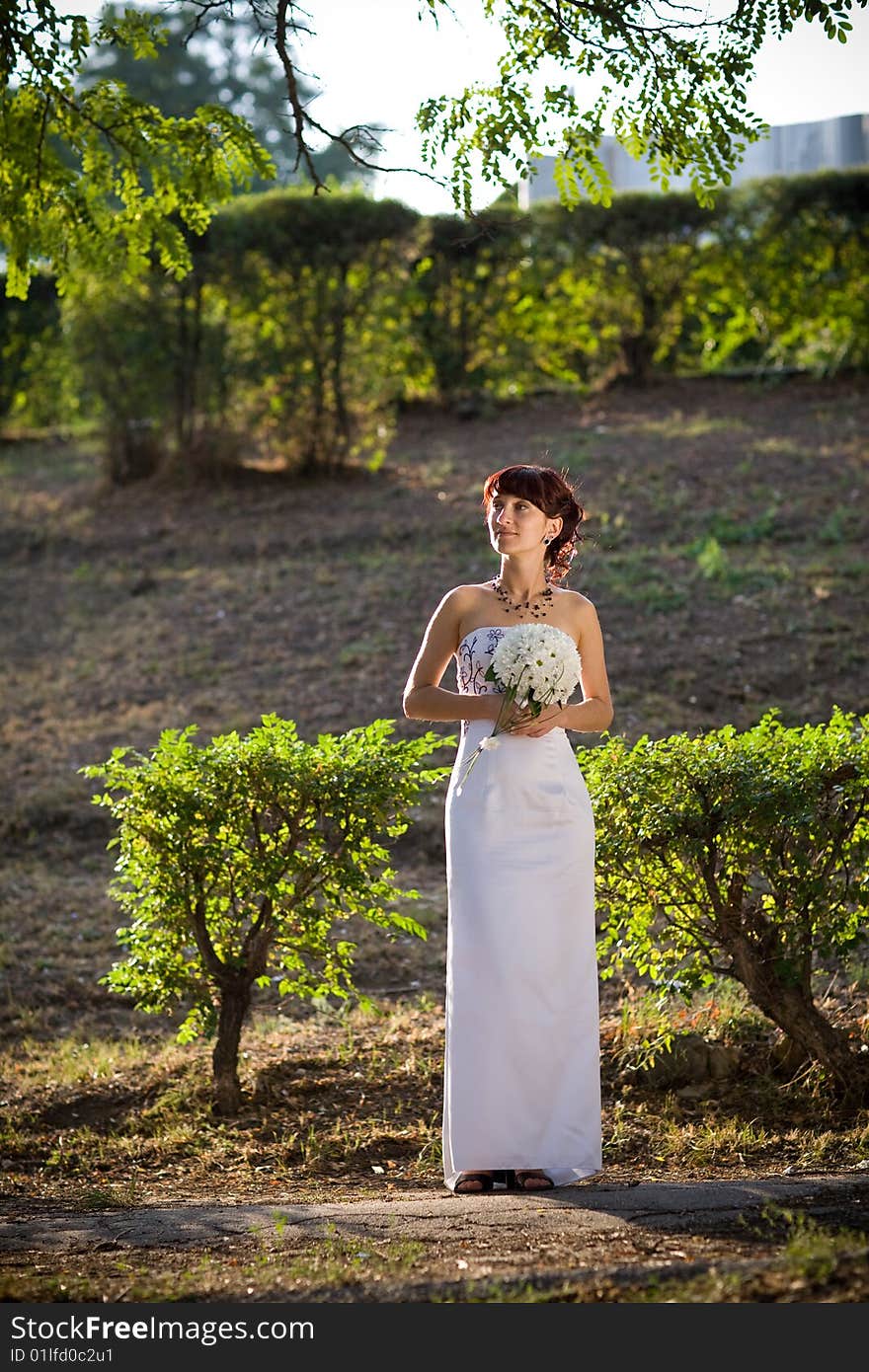 Bride in the evening park